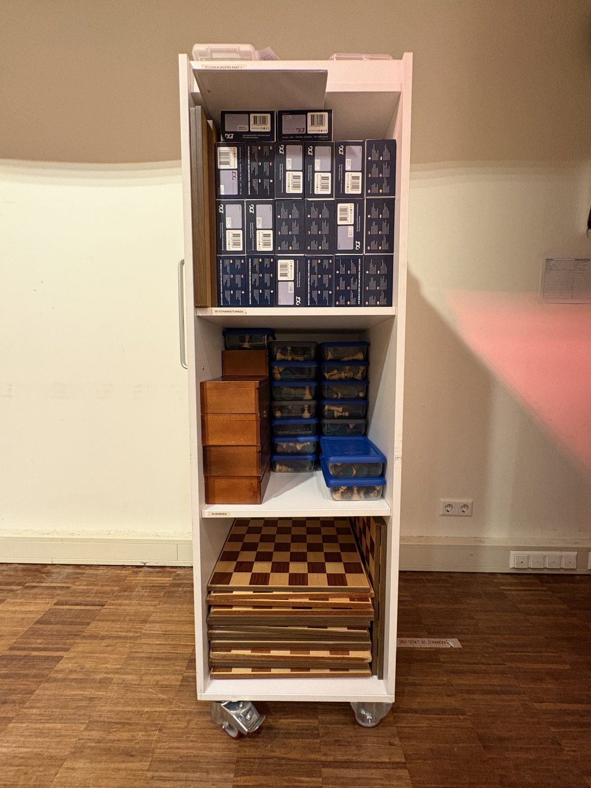 End of the evening: pieces into boxes, boards into stacks, the room returned to the cinema.